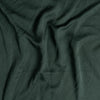 Madera Luxe Crib Sheet | Juniper | A close up of Tencel™ fabric in Juniper, a deep green tone.