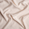 Madera Luxe Crib Sheet | Pearl | A close up of Tencel™ fabric in pearl, a nude-like, soft rose pink tone.