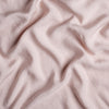 Madera Luxe Crib Sheet | Rouge | A close up of Tencel™ fabric in rouge, a mid-tone blush pink.