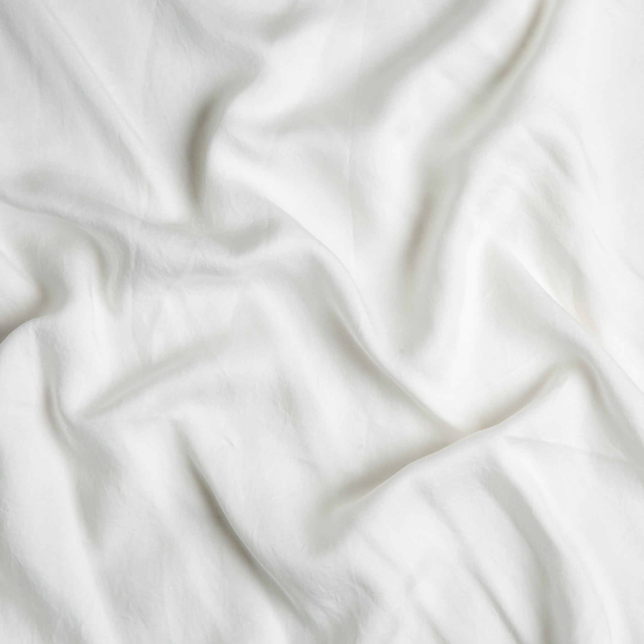 Madera Luxe Crib Sheet | Winter White | A close up of Tencel™ fabric in winter white, softer and warmer in tone than classic white.
