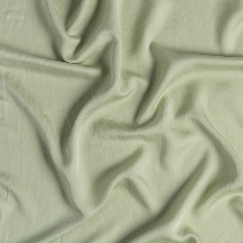 Madera Luxe Twin Fitted Sheets | Desert Sage | close-up of tencel fabric gently rumpled in desert sage, a serenely elegant green, offering a hushed hue.