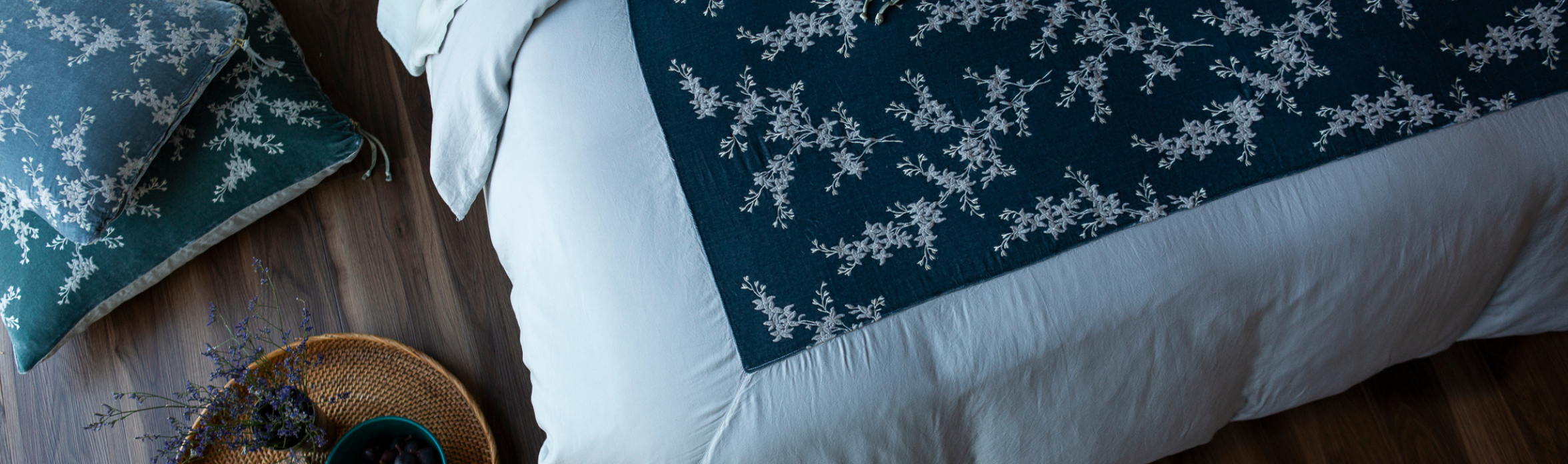 Lynette Luxe: An overhead shot of a Bella Notte Linen dressed bed featuring soft Tencel Duvet cover in Mineral with Lynette Throw Pillow in Eucalyptus and Lynette Luxe sham in Mineral 