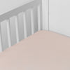 Madera Luxe Crib Sheet | Pearl | crib sheet shown on a mattress shown from overhead into the corner of a crib.