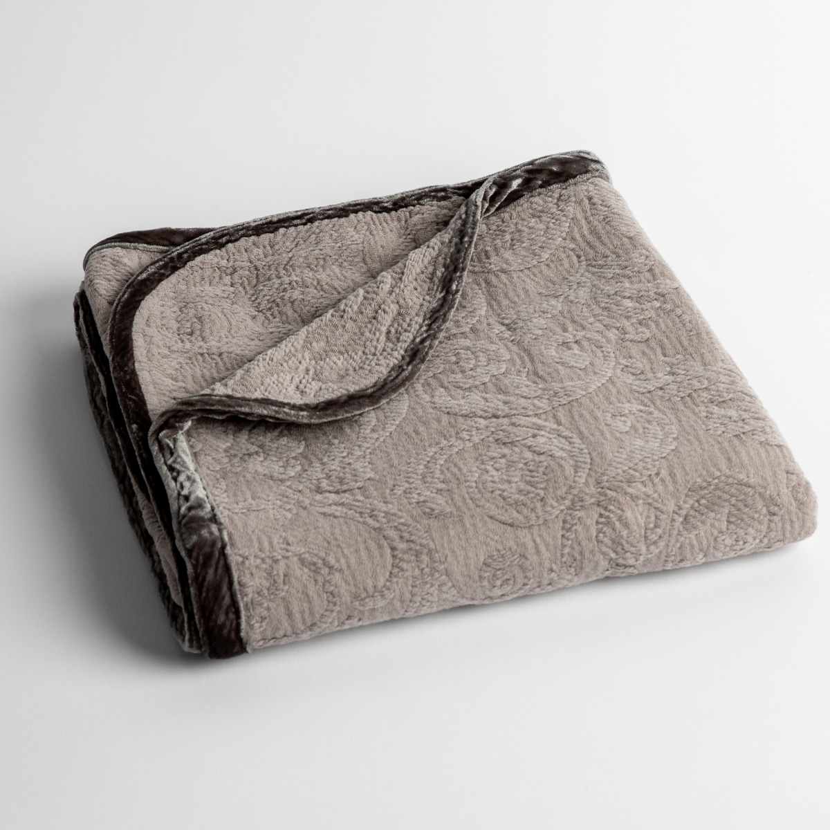 Adele Baby Blanket | Fog | a folded blanket with the corner turned down to show the trim against a white background, shot from an overhead angle.