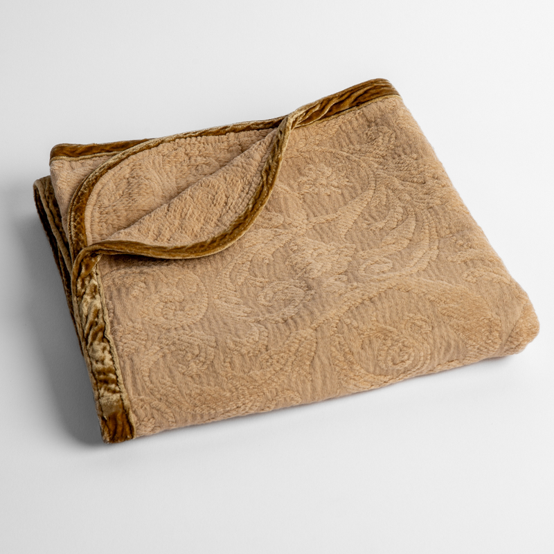 Adele Baby Blanket | Honeycomb | a folded blanket with the corner turned down to show the trim against a white background, shot from an overhead angle.