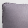Austin Sham | French Lavender | a close up of the corner of a  midweight linen pillow with raw edge trim on its gusset.