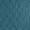 Austin Coverlet | Cenote | A close up of quilted midweight linen fabric in cenote, a vibrant, ocean-inspired blue-green.