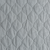Austin Coverlet | Cloud | A close up of quilted midweight linen fabric in cloud, a soft, subtle sky blue-grey.