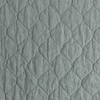 Austin Coverlet | Eucalyptus | A close up of quilted midweight linen fabric in eucalyptus, a soft light green.