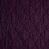 Austin Coverlet | Fig | A close up of quilted midweight linen fabric in fig, a richly saturated purple-garnet.