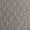 Austin Coverlet | Fog | A close up of quilted midweight linen fabric in fog, a neutral-warm, soft mid-tone grey.