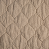 Austin Coverlet | Honeycomb | A close up of quilted midweight linen fabric in honeycomb, a warm golden tone.