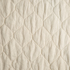 Austin Coverlet | Parchment | A close up of quilted midweight linen fabric in parchment, a warm, antiqued cream.