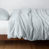 Austin Duvet Cover | Cloud | Midweight linen duvet cover in cloud on a bed, side view.