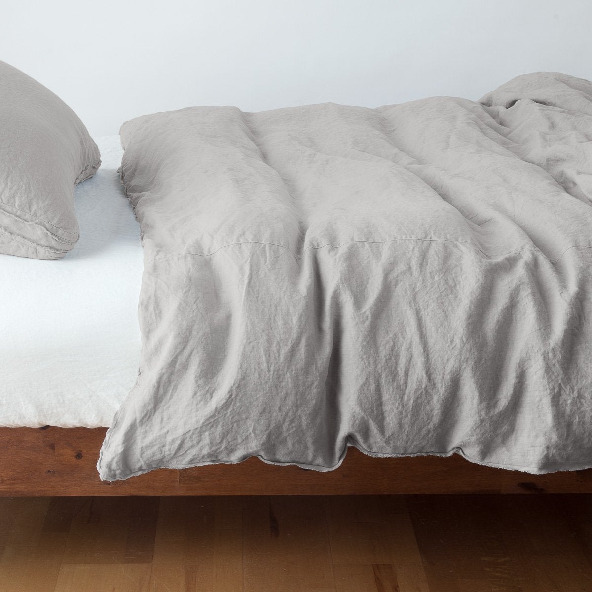Austin Duvet Cover | Fog | Midweight linen duvet cover in fog on a bed, side view.
