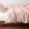 Austin Duvet Cover | Rouge | Midweight linen duvet cover in rouge on a bed, side view.