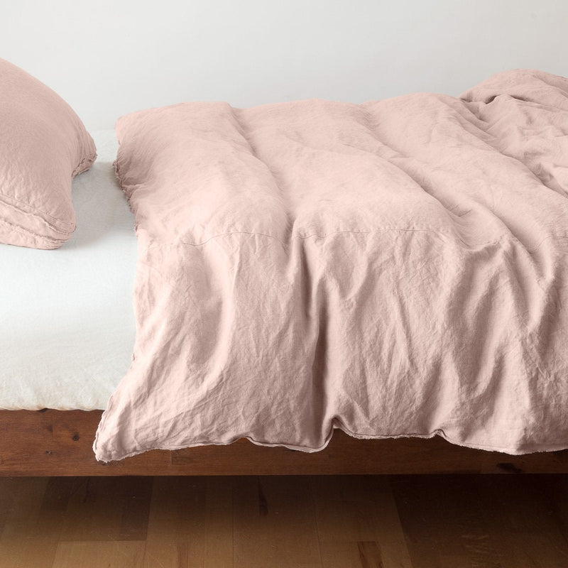 Austin Duvet Cover | Rouge | Midweight linen duvet cover in rouge on a bed, side view.