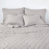 Austin coverlet in fog, end of bed view, with monochromatic sheeting and shams.