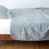Austin Coverlet | Mineral | Quilted midweight linen coverlet in mineral on a bed - side view.