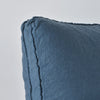 Midnight | Close-up angle of the corner of an Austin sham, highlighting the raw edge trim on either side of the gusset.