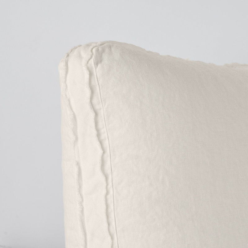 Parchment | Close-up angle of the corner of an Austin sham, highlighting the raw edge trim on either side of the gusset.