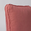 Austin Throw Pillow | Poppy | close up of midweight linen pillow corner with raw edges trimming its gusset.