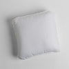 Austin Throw Pillow | White | midweight linen 18x18 inch throw pillow shot from overhead against a white background.