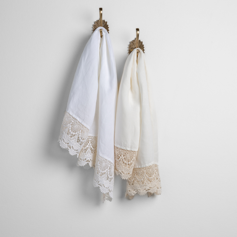 Mattine Guest Towel | two linen with lace guest towels in white and winter white on decorative towel hooks mounted on a white wall. 