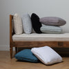 Austin Throw Pillow | daybed bench with multiple midweight linen throw pillows both on the daybed and on the floor.