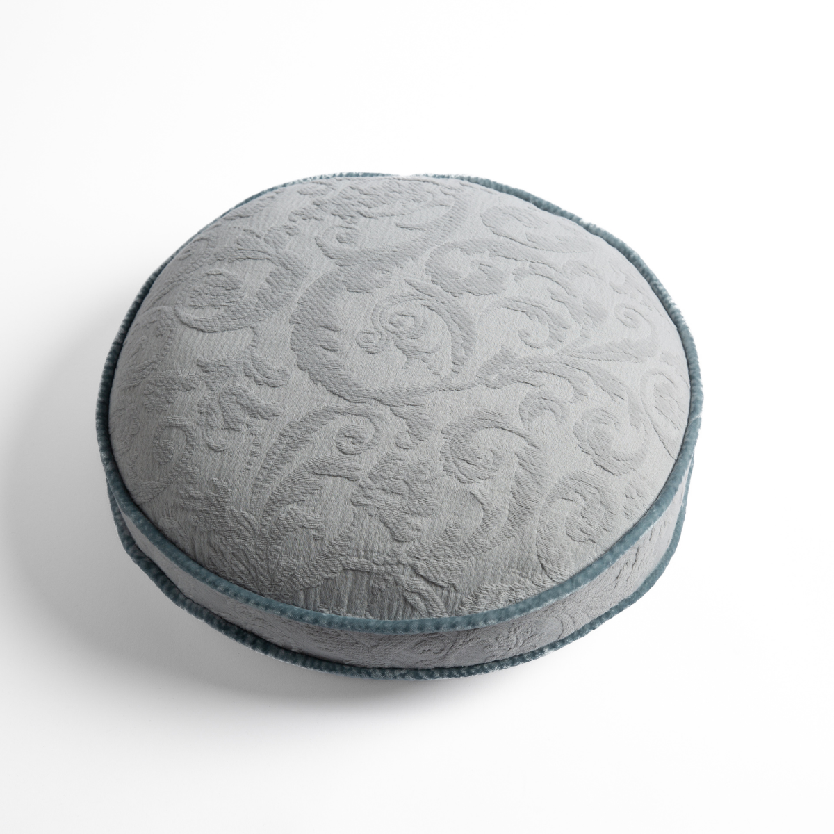 Adele Throw Pillow | Cloud | Organic cotton damask round pillow with silk velvet trim on white background — overhead angle.