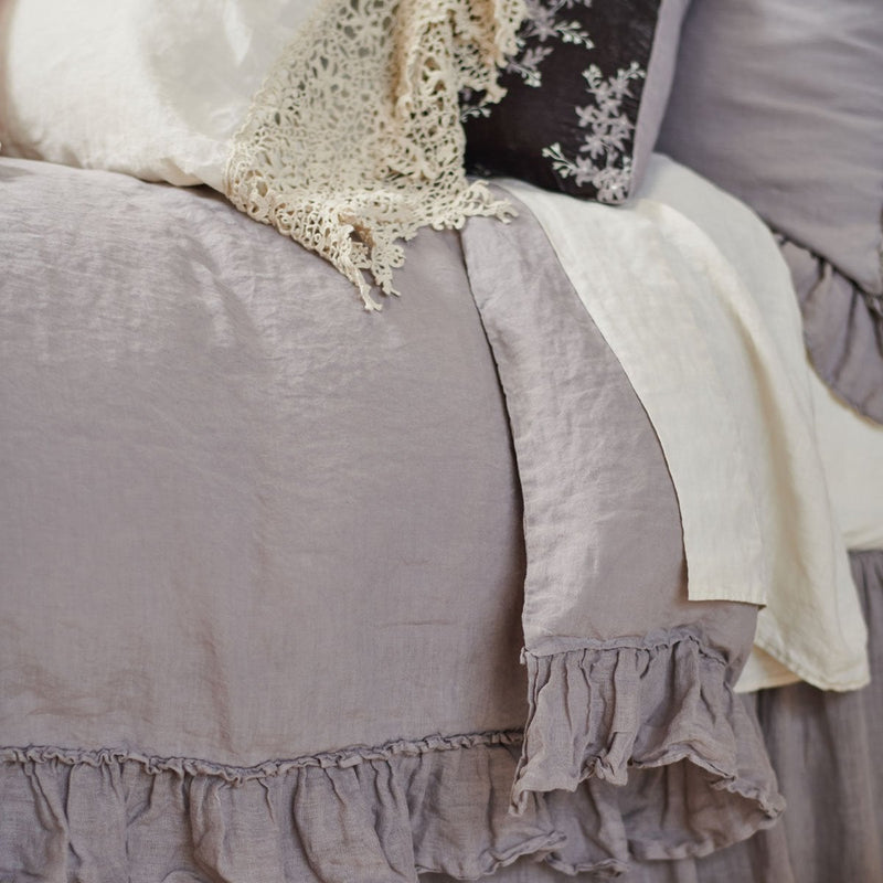 Moonlight | Linen whisper duvet cover with parchment sheets and sleeping pillow - close-up three-quarter angle.