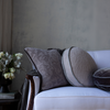 Adele Throw Pillow | Square and round pillows on white couch with flowers on side table against a neutral grey wall.