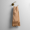 Mattine Guest Towel | Honeycomb | linen with mattine lace trimmed guest towel on a decorative towel ring mounted on a white wall.
