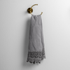 Mattine Guest Towel | Moonlight | linen with mattine lace trimmed guest towel on a decorative towel ring mounted on a white wall.