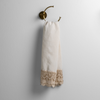 Mattine Guest Towel | Parchment | linen with mattine lace trimmed guest towel on a decorative towel ring mounted on a white wall.