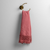 Mattine Guest Towel | Poppy | linen with mattine lace trimmed guest towel on a decorative towel ring mounted on a white wall.