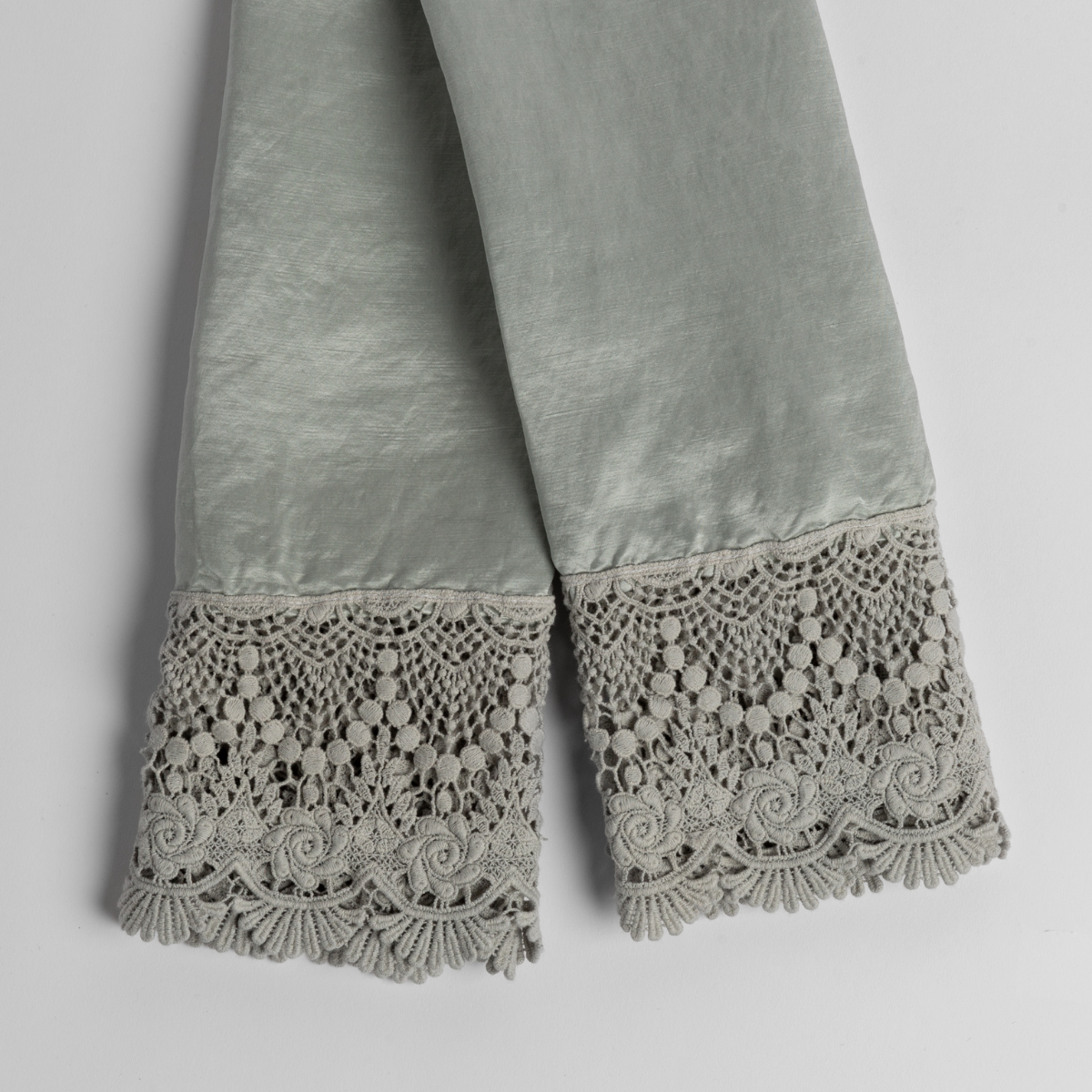 Paloma Pillowcase (Single) | Cloud | charmeuse with mattine lace pillowcases folded and slightly overlapping, shot from overhead against a white background.