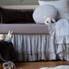 Linen Crib Sheet | Close up of crib sheet in moonlight shown with light blue bedding and a small white stuffed bunny.