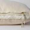 Harlow Throw Pillow | Parchment | Close-up of charmeuse gusset, raw-edge trim, and brass zipper detail on Harlow pillow - side view.