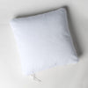 Harlow Throw Pillow | White | Cotton velvet 24 by 24 pillow on a plain background - overhead view.