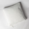 Harlow Throw Pillow | Winter White | Cotton velvet 24 by 24 pillow on a plain background - overhead view.