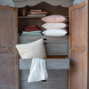 Bria Fitted Sheet | Bria sheets and pillow cases stacked inside an antique armoire in a variety of colors.