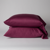 Bria Pillowcase (Single) | Fig | Two cotton sateen sleeping pillows, stacked neatly against a white backdrop - side view.