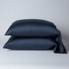 Bria Standard Pillowcase (Single) | Midnight | Two cotton sateen sleeping pillows, stacked neatly against a white backdrop - side view.