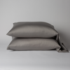 Bria Pillowcase (Single) | Moonlight | Two cotton sateen sleeping pillows, stacked neatly against a white backdrop - side view.