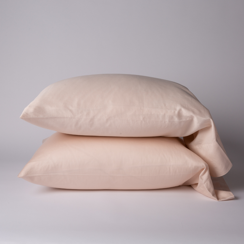 Bria Standard Pillowcase (Single) | Pearl | Two cotton sateen sleeping pillows, stacked neatly against a white backdrop - side view.
