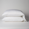 Bria Standard Pillowcase (Single) | White | Two cotton sateen sleeping pillows, stacked neatly against a white backdrop - side view.
