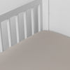 Bria Crib Sheet | Fog | Cotton sateen crib sheet shown from a slight overhead angle into  an inside corner of a crib.