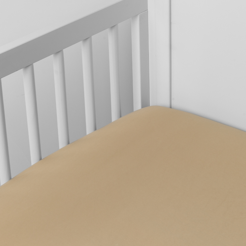 Bria Crib Sheet | Honeycomb | Cotton sateen crib sheet shown from a slight overhead angle into  an inside corner of a crib.