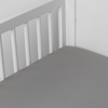 Bria Crib Sheet | Moonlight | Cotton sateen crib sheet shown from a slight overhead angle into  an inside corner of a crib.